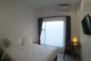 Onesouth Boutique Hotel Pulau merah客房内的一张或多张床位