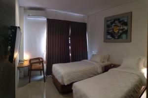 Onesouth Boutique Hotel Pulau merah客房内的一张或多张床位