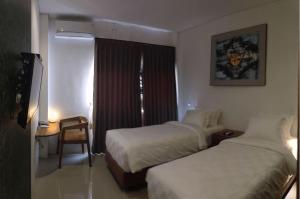 Onesouth Boutique Hotel Pulau merah客房内的一张或多张床位