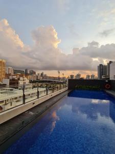 a swimming pool on the roof of a building at Lion Peak Hotel Hamilton in Singapore