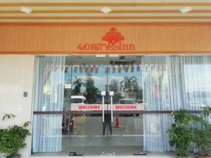 a front door of a store with a sign on it at 4orty Inn in Bintulu