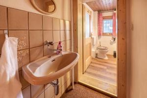 a bathroom with a sink and a toilet at Alpenchalet Bergprinzessin in Mühlen