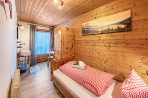 a room with a bed in a wooden room at Alpenchalet Bergprinzessin in Mühlen