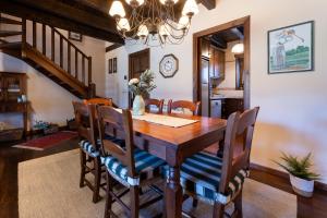 a dining room with a wooden table and chairs at Casa Fontanals de Cerdanya in Soriguerola