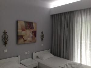 Posteľ alebo postele v izbe v ubytovaní Maria Suites