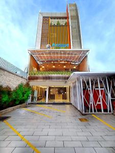 a building with a parking lot in front of it at Arawa Traveller's Inn Motel in Makassar