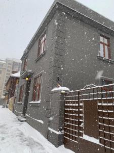 a building with snow on it in a city at Emily in Rīga