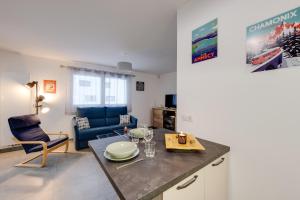 une cuisine avec une table et une chaise bleue dans l'établissement Le Concert - Beautiful appartment with garage for 4 people near beach, à Annecy