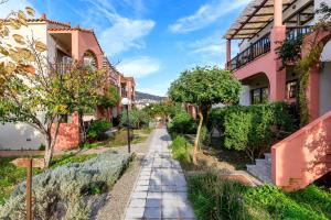a street in a village with houses at Rigas Hotel Skopelos by GHH in Skopelos Town