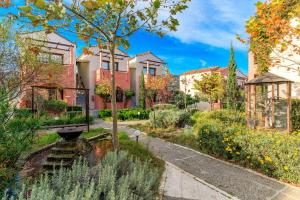 a garden in front of a building at Rigas Hotel Skopelos by GHH in Skopelos Town