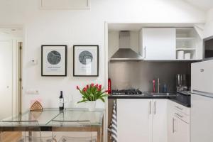 a kitchen with white cabinets and a glass counter top at Yess in Vinkeveen