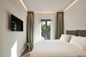 Giường trong phòng chung tại NLH KERAMEIKOS - Neighborhood Lifestyle Hotels