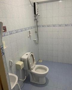 a bathroom with a toilet and a sink at Royal Beach Dhigurah in Dhigurah