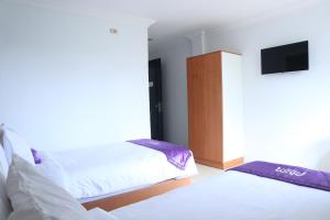 Ένα ή περισσότερα κρεβάτια σε δωμάτιο στο Plum Hotel Lading Banda Aceh