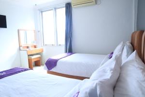 Ένα ή περισσότερα κρεβάτια σε δωμάτιο στο Plum Hotel Lading Banda Aceh