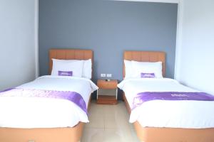 Ένα ή περισσότερα κρεβάτια σε δωμάτιο στο Plum Hotel Lading Banda Aceh