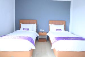 Ένα ή περισσότερα κρεβάτια σε δωμάτιο στο Plum Hotel Lading Banda Aceh