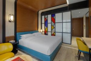 a bedroom with a bed and a table and a desk at Andaz Residence by Hyatt - Palm Jumeirah in Dubai