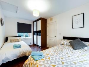 a bedroom with two beds and a window at Cheerful 5-BDR/3-BATH House w/ Free Parking in Reading