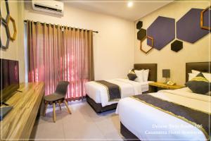 Tempat tidur dalam kamar di Casananta Seminyak