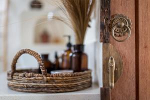 a wicker basket sitting on a counter with bottles in it at Drop In Surf Lodge in Kuta Lombok