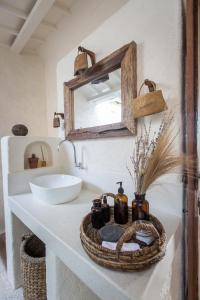 a bathroom with a sink and a mirror on a counter at Drop In Surf Lodge in Kuta Lombok