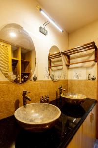 a bathroom with two sinks and a large mirror at Sea Night Hotel in Phan Thiet