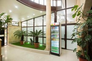 a soda machine in a building with plants at Hotel Teplo in Sochi