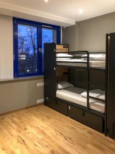 a room with three bunk beds and a window at Generator Berlin Prenzlauer Berg in Berlin