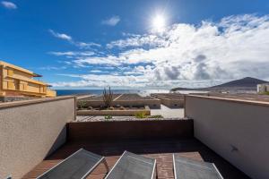 a view of the ocean from the balcony of a house at MEDANO4YOU Surfers Paradise Casa Medano in El Médano +20 photos