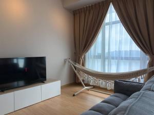 a living room with a couch and a large window at Kuantan Seaview Studio@Imperium Residence TgLumpur in Kuantan