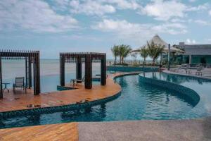 a pool at a resort with the ocean in the background at Kuantan Seaview Studio@Imperium Residence TgLumpur in Kuantan