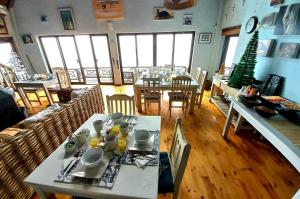 a dining room with tables and chairs and a christmas tree at Oyster Bay Beach Lodge in Oyster Bay