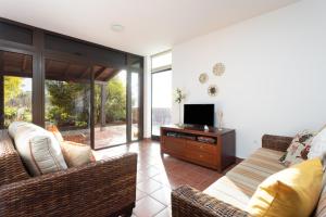a living room with a couch and a tv at Home2Book Amazing Teide View & Terrace in Sauzal