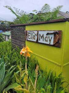 a sign on the side of a green building at Ella May Holiday Flats in Tuross Heads
