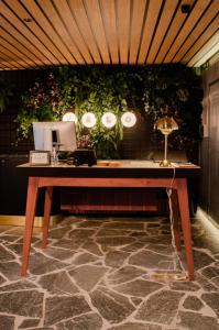 
a wooden table with a laptop on top of it at Yalo Urban Boutique Hotel Gent in Ghent
