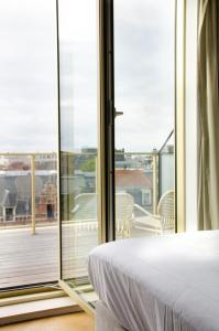 
a hotel room with a view of the ocean at Yalo Urban Boutique Hotel Gent in Ghent
