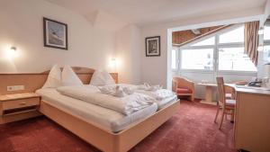 Postel nebo postele na pokoji v ubytování Hotel Victoria