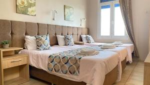 a bedroom with two beds with towels on them at Pelineon Rooms in Chios