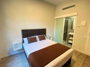 A bed or beds in a room at BCN Urbaness Hotels Bonavista