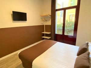 A bed or beds in a room at BCN Urbaness Hotels Bonavista