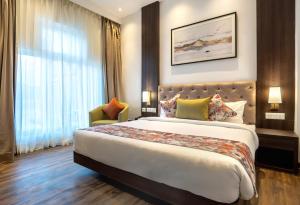 מיטה או מיטות בחדר ב-Hotel Le ROI Lake View Koti