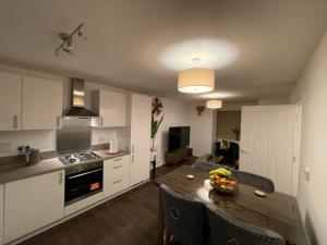 una cocina con una mesa con un bol de fruta. en A luxurious 2-Bedroom flat in Rugby., en Rugby