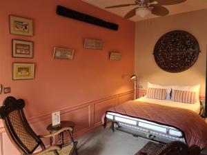 a bedroom with a bed and a ceiling fan at La Résidence des Indes in La Rochelle