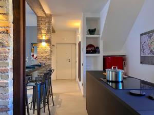 罗马RomeAsYouLike - Magenta Loft的厨房设有带凳子的酒吧