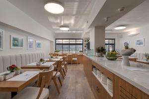 a restaurant with tables and chairs and a counter at No 15 Ermou Hotel in Thessaloniki