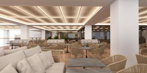 a lobby with couches and tables and chairs at Ammoa Luxury Hotel & Spa Resort in Nikiti