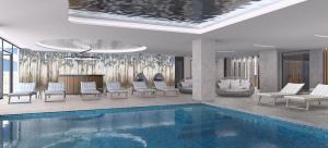 a living room with a pool and chairs and a fireplace at Ammoa Luxury Hotel & Spa Resort in Nikiti