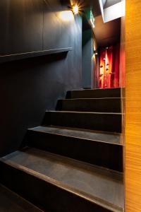 a set of stairs in a room with black walls at Zrooms&Suites Hostel Boutique in Zaragoza