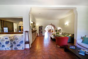 a living room with a couch and a table at Rigas Hotel Skopelos by GHH in Skopelos Town +79 photos